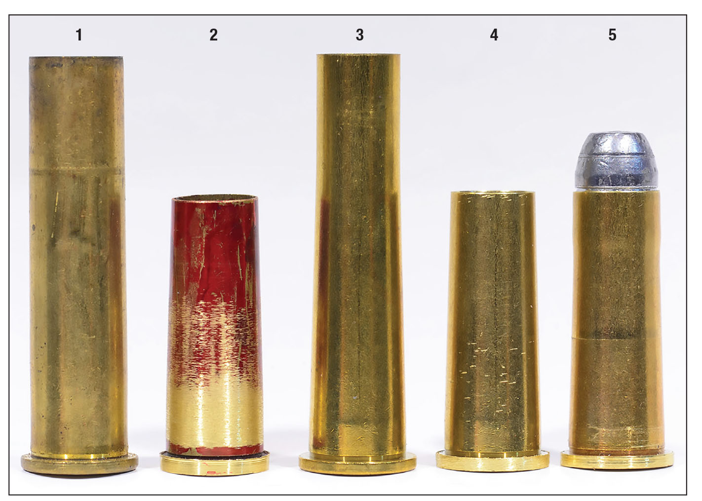 Stages of production: (1) A .45-70 case, (2) a prototype made by Lee Shaver from a .45-70 case, (3) a new Starline .40-65 case, (4) a new 11.2x36 Austrian and (5) a loaded cartridge, ready for fireforming.